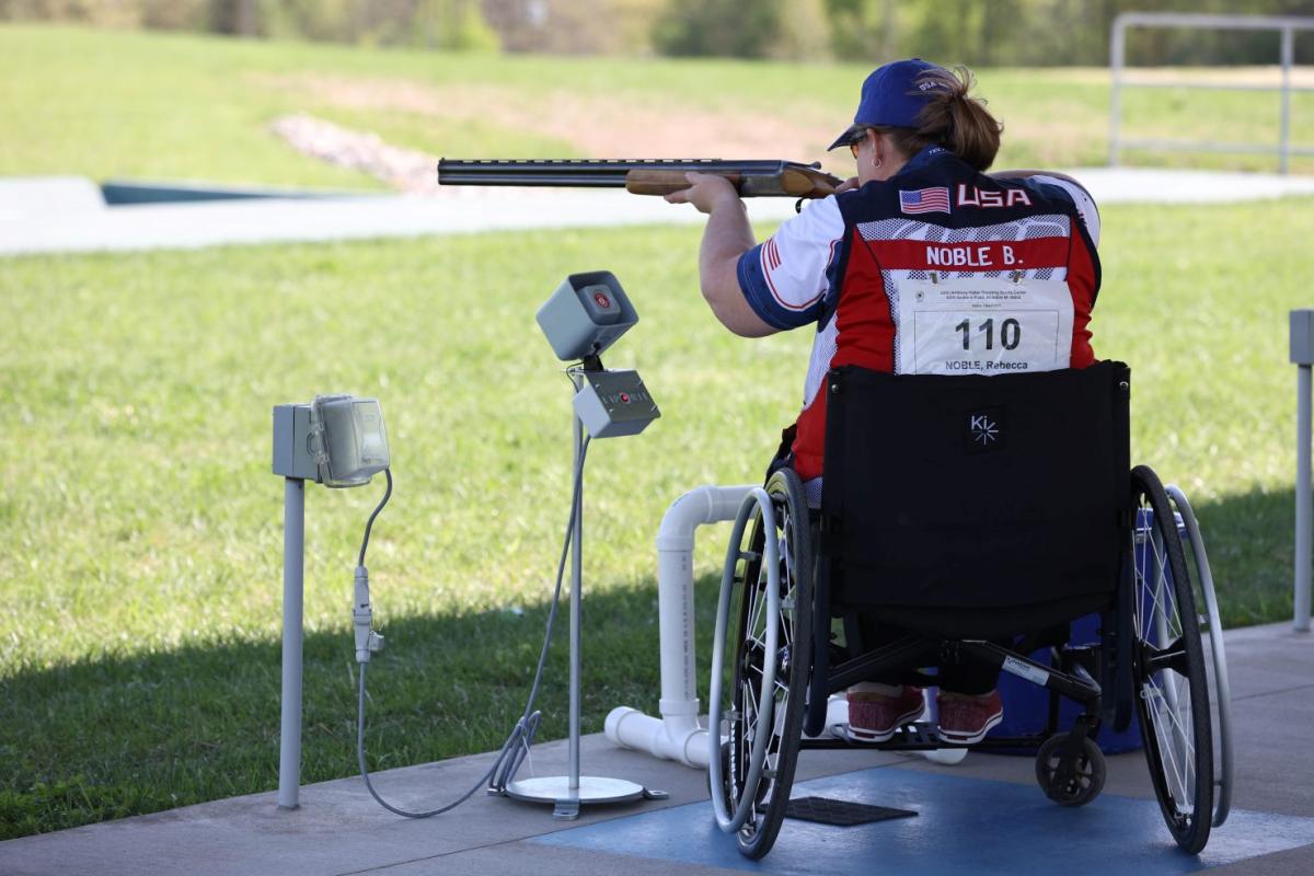 A female Para trap shooter in a wheelchair during a competition